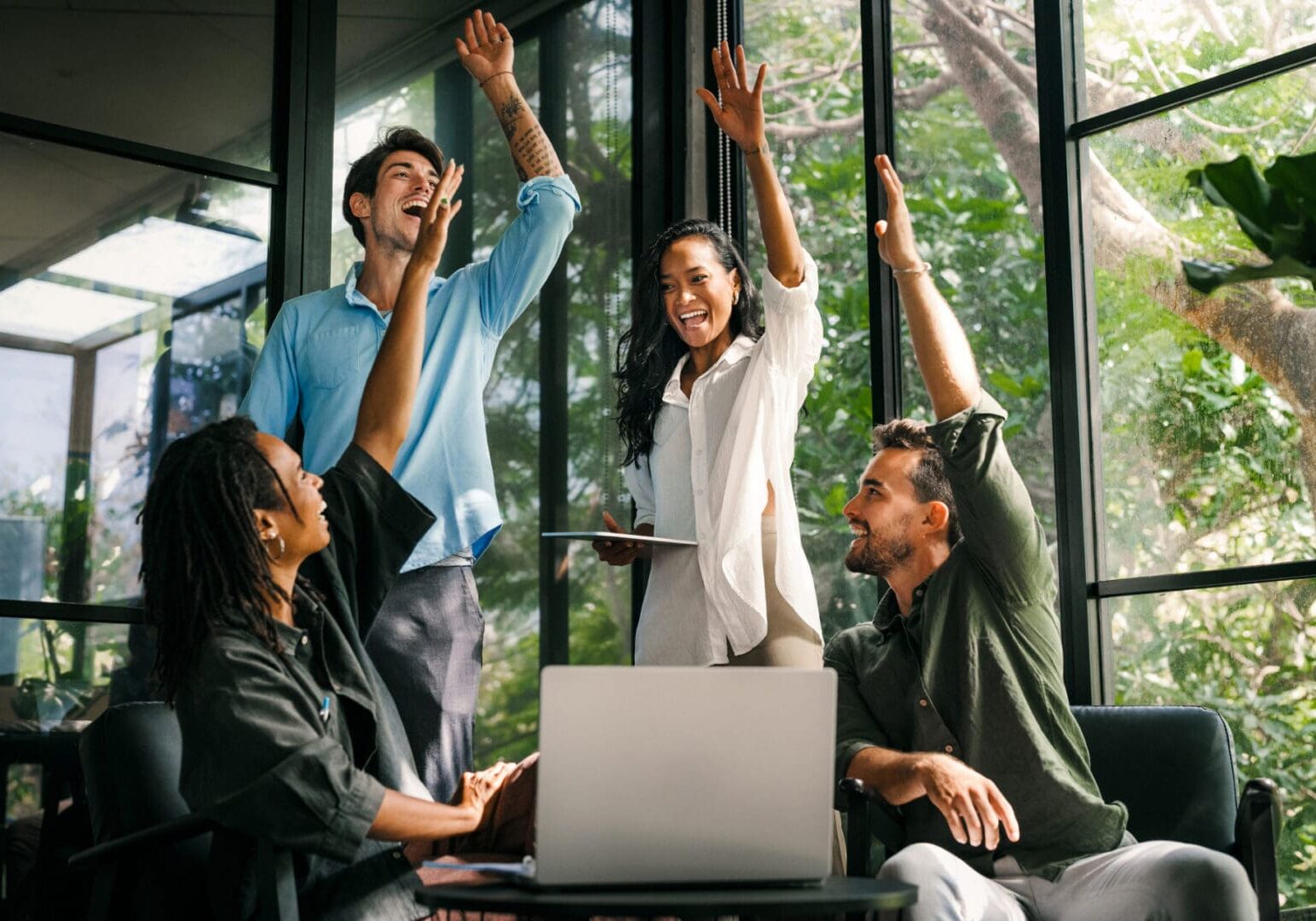 Group of colleagues high-fiving joyfully