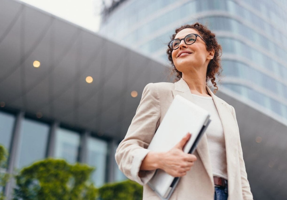 Professional woman smiling with laptop